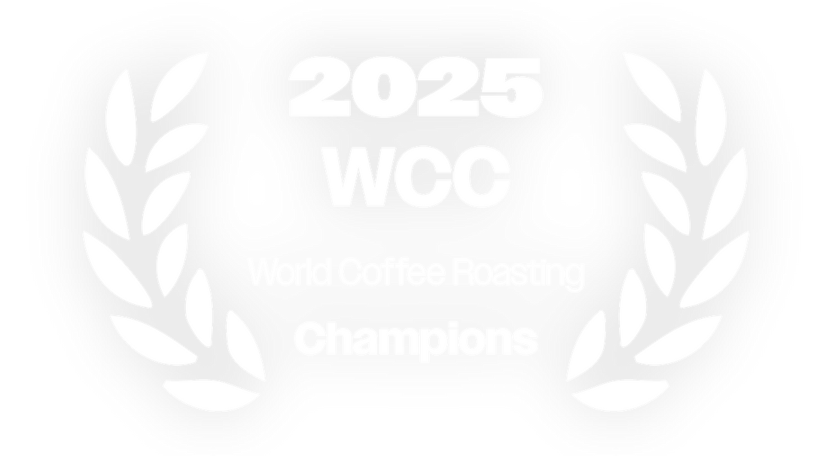 Mikaël Portannier – 2025 World Coffee Roasting Championship winner badge, white laurel wreath with “2025 WCC – World Coffee Roasting Champions” text, highlighting his World Champion title and MOF distinction.