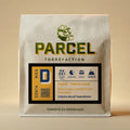 White kraft coffee bag from Parcel Torrefaction featuring Decaf Volcan Azul Costa Rica with gold and navy label, honey process, 1600m altitude